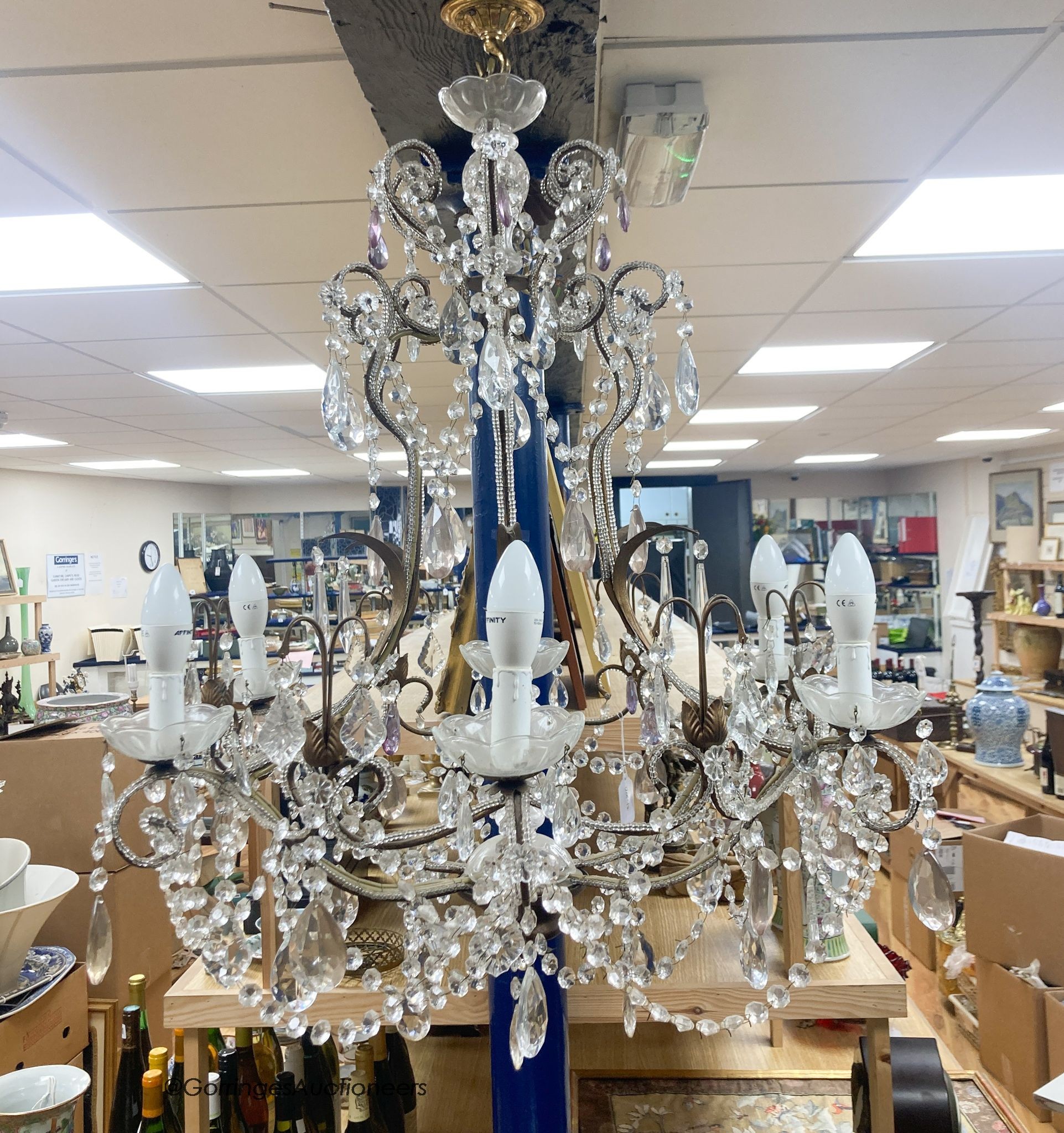 A gilt metal cut glass and lustre hung seven light chandelier 84cm high